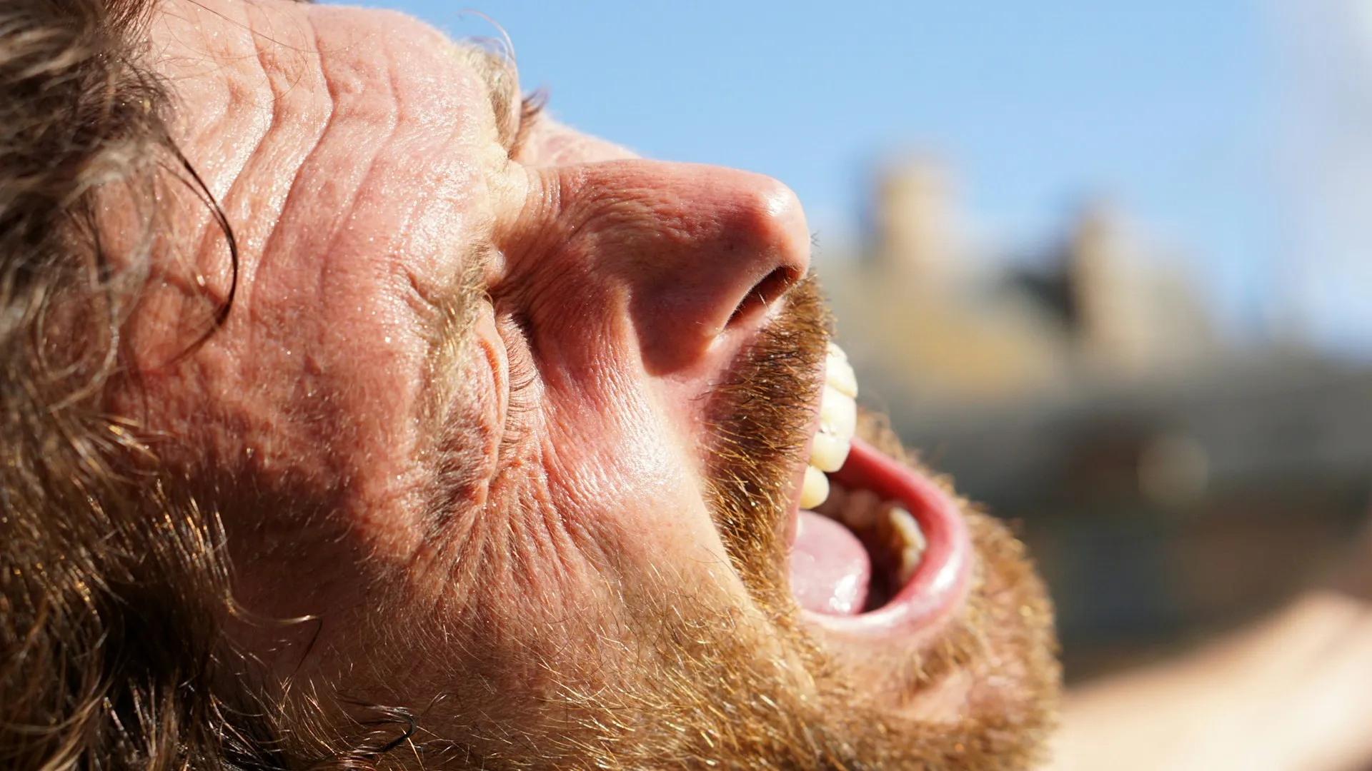 a close up of a man with his mouth open