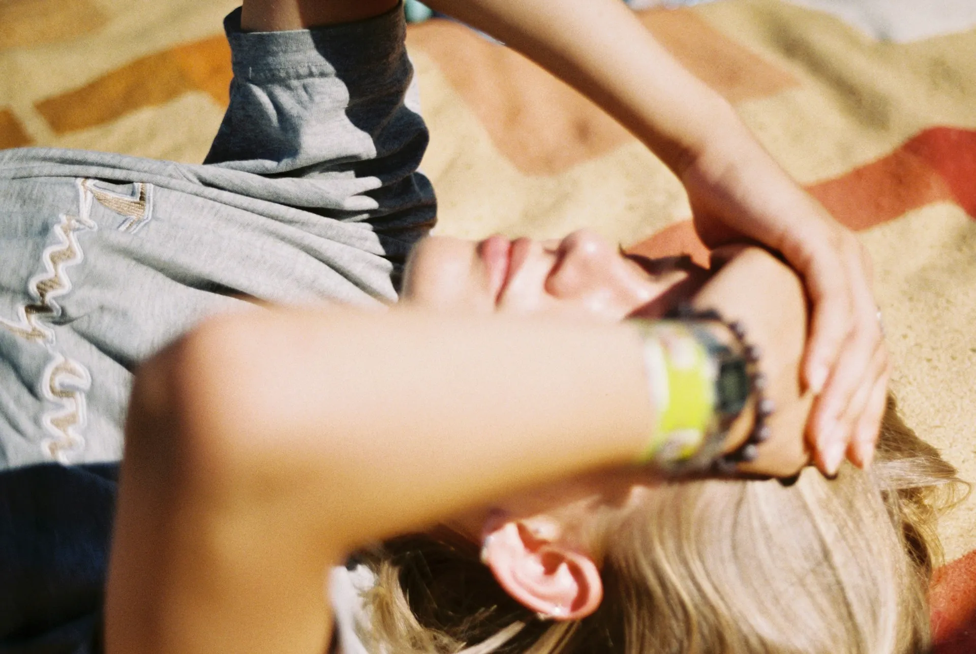 a woman laying on the ground next to a man